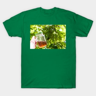 Hand holding a glass mug of cold tea T-Shirt